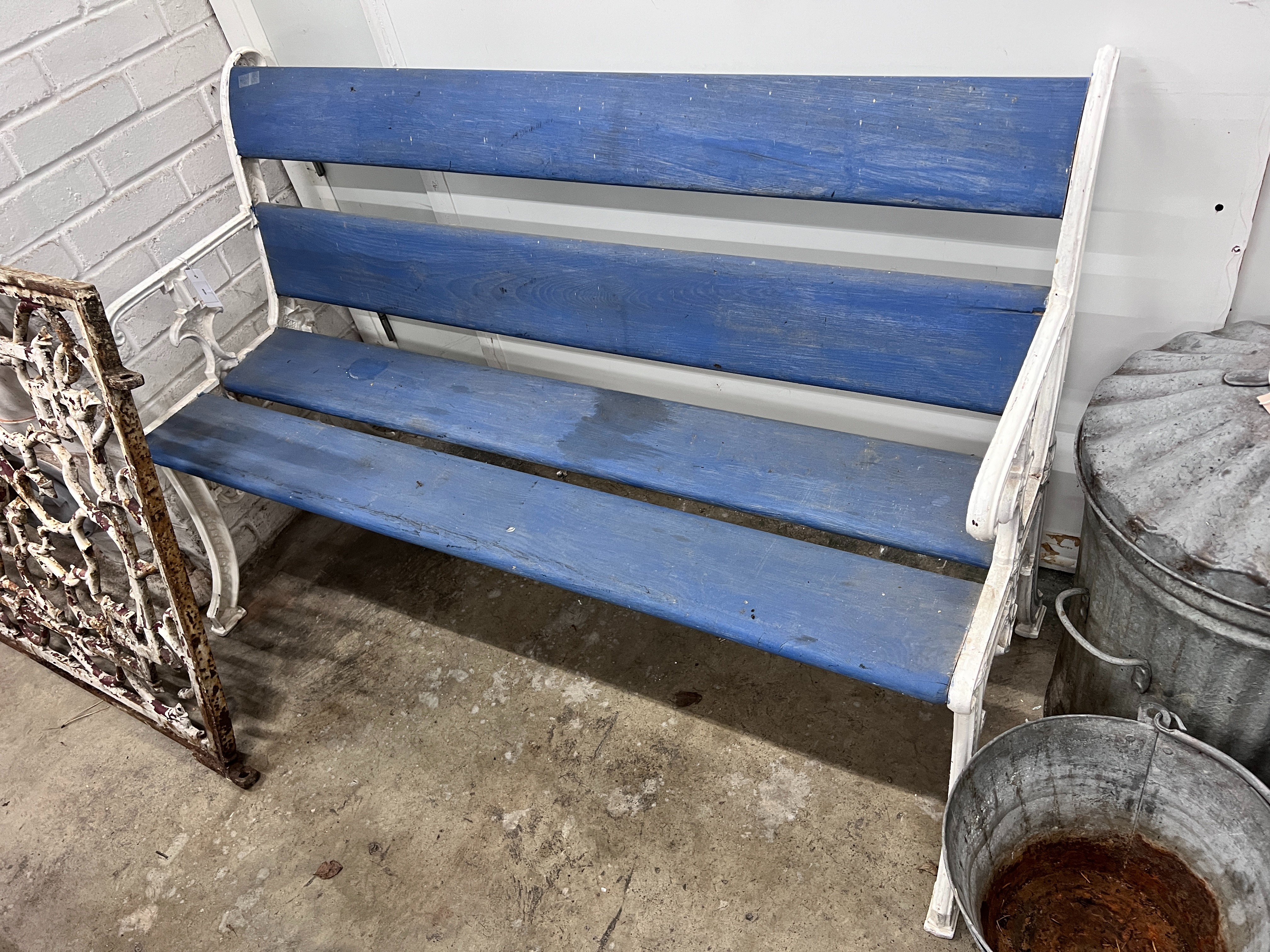 A Victorian style painted cast iron and wooden slatted garden bench, length 131cm, depth 54cm, height 84cm
